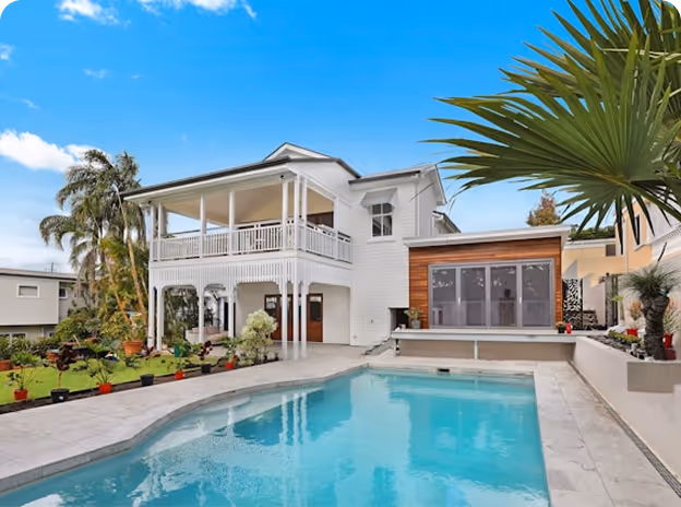 Cleaned pool of a 2 story residential house with an open view style balcony. 